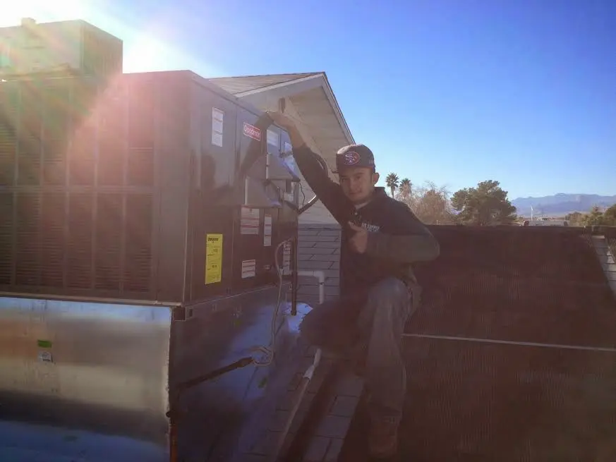 HVAC technician performing Boiler Repair on a rooftop unit in Seattle